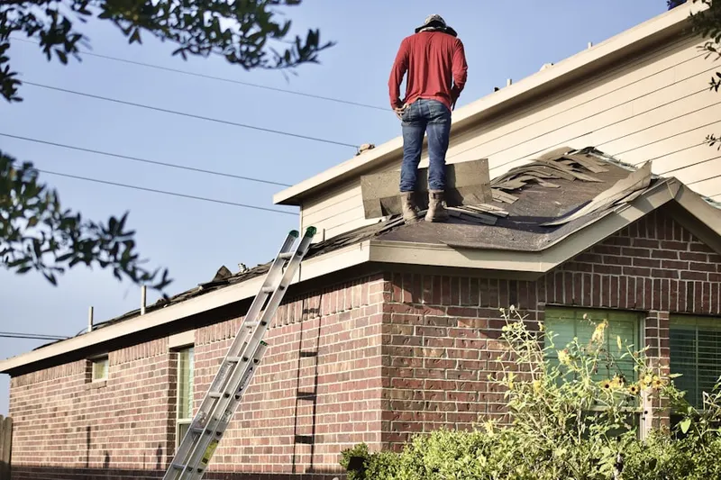Professional roofer working on a residential roof in Burning Tree Estates